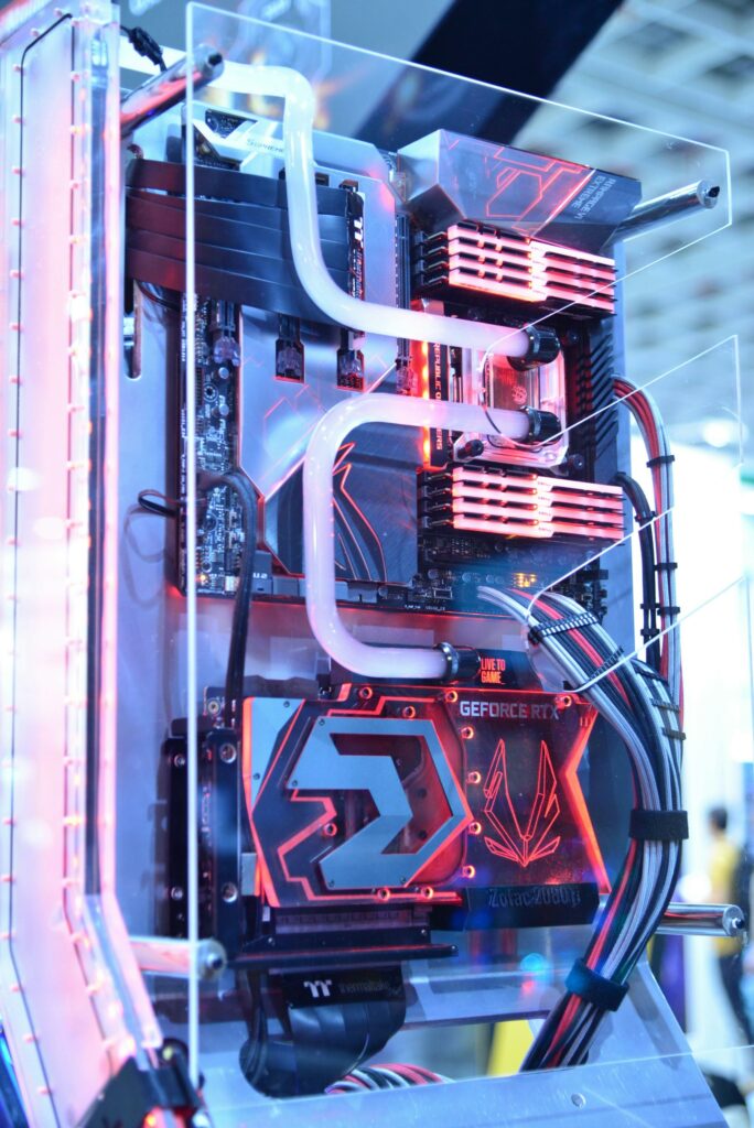 Close-up view of a custom gaming PC with water cooling and LED lights, highlighting advanced technology.